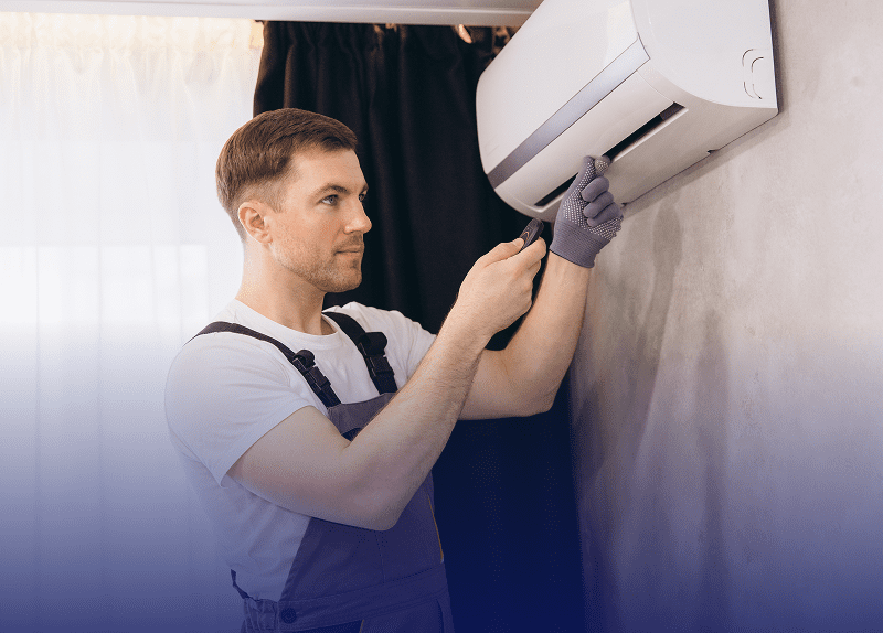 Technician repairing wall-mounted air conditioner