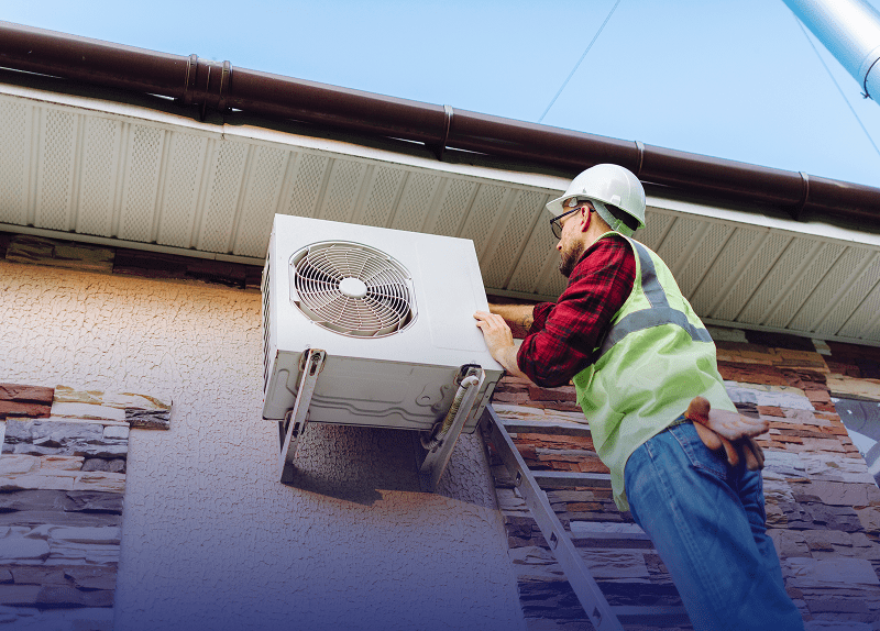 Worker maintaining building's HVAC system