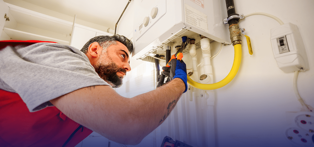 Plumber fixing a gas water heater